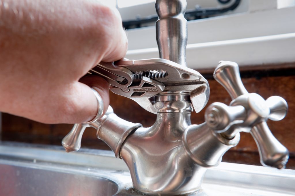faucet being installed by a plumber