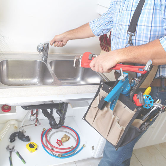 plumber working on a faucet