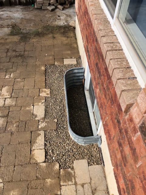 a basement window with a window well installed