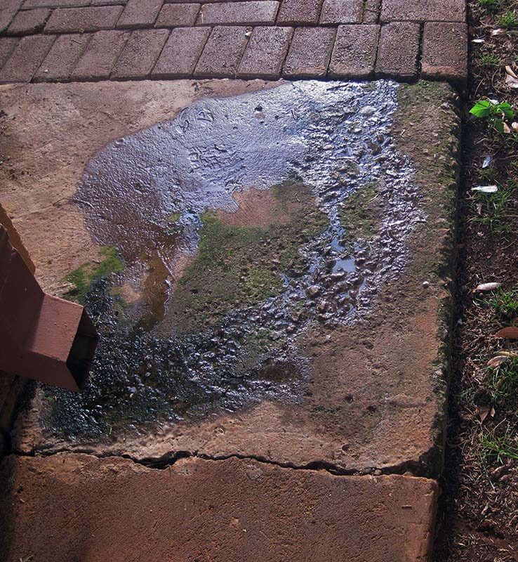 downspout causing cracks in cement near foundation