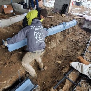 Plumber installing trench drain