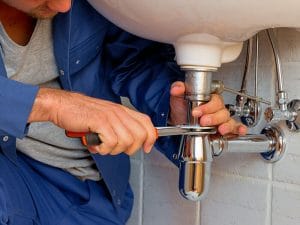 plumber installing faucet in Vaughan