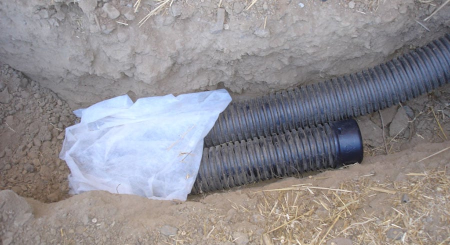 french drain being installed in the yard