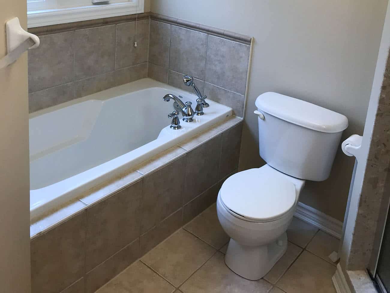 Clogged bathroom tub with toilet