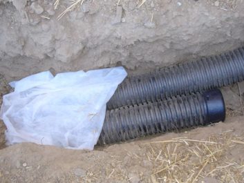 french drain being installed in the yard