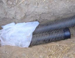 french drain being installed in the yard